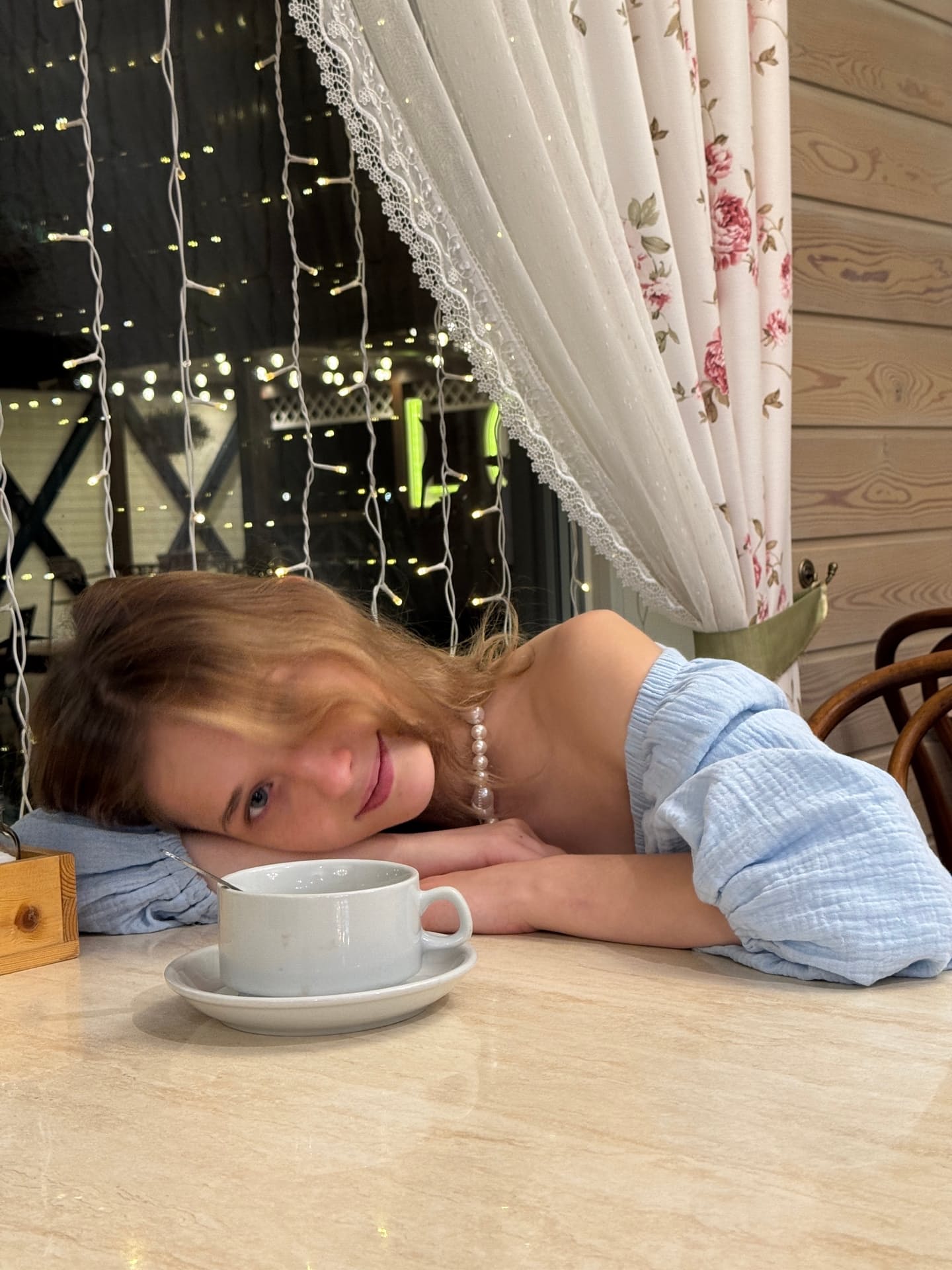 Ein Mädchen mit heller Haut und Sommersprossen zeigt sich im Freien mit ihren Tattoos